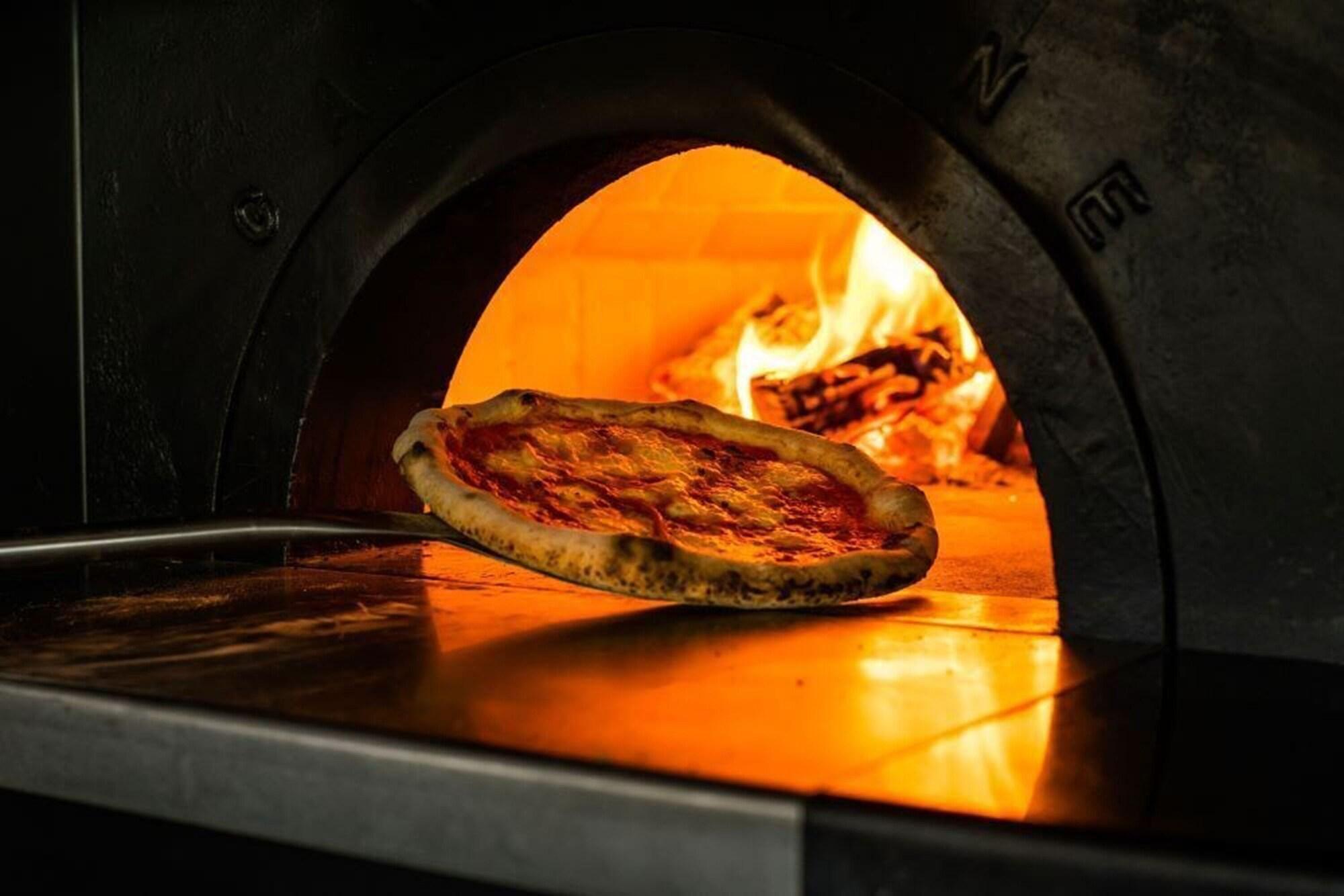 Ace Hotel Kyōto Esterno foto Pizza being removed from a wood-fired oven